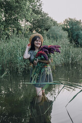 In combination with nature and flowers, harmony with oneself, happy moments, peace and balance. A charming girl in nature.