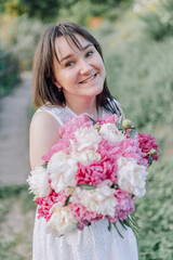 In combination with nature and flowers, harmony with oneself, happy moments, peace and balance. A charming girl in nature.