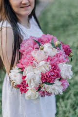 In combination with nature and flowers, harmony with oneself, happy moments, peace and balance. A charming girl in nature.