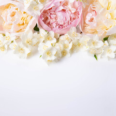 Square floral layout with soft peonies and blooming jasmine on white background. Perfect for social...