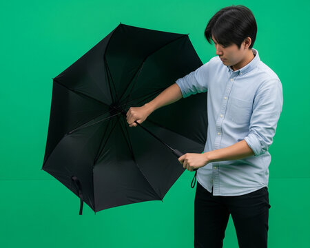Person Opening Umbrella In Front Of Green Screen