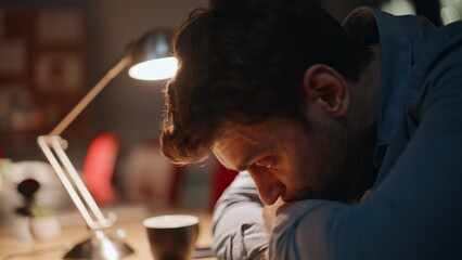 Sleepy employee sitting workplace late evening closeup. Overworked businessman