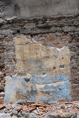 Ruined Brick Wall with Peeling Plaster and Debris
