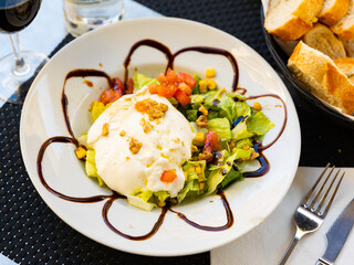 Appetizing burrata cheese served fresh vegetable salad