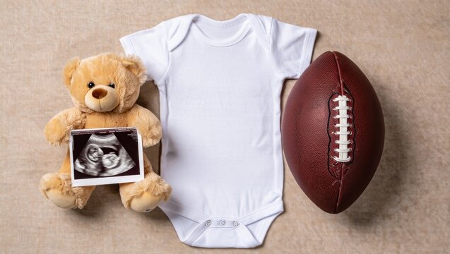 A Heartwarming Announcement of a New Arrival: Baby Onesie, Ultrasound Photo, Teddy Bear, and Football Celebrate Family and Future Moments Together