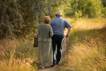 Happy elderly people walking in the park on a sunny day