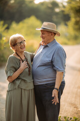 Happy elderly people walking in the park on a sunny day