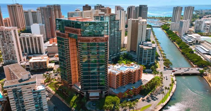 Magnificent design and style of the buildings constructed on the shore of the Ala Wai Canal. Drone flight around the Waikiki resort in Honolulu, Hawaii, USA.