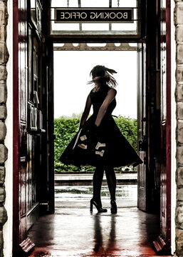 A woman in a black dress and heels is standing in a doorway, holding money, with the sign "BOOKING OFFICE" above her.