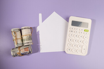 Budgeting for Homeownership – Paper House with Cash and Calculator