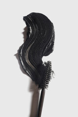 Mascara brush smeared sample swatch texture isolated on light grey