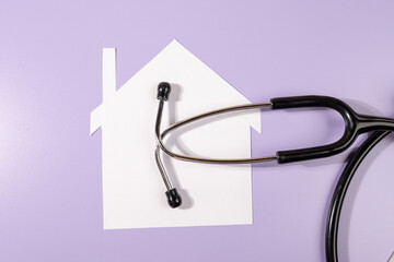 Home and Health Connection – Stethoscope with Paper House on Desk