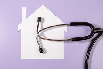 Home and Health Connection – Stethoscope with Paper House on Desk
