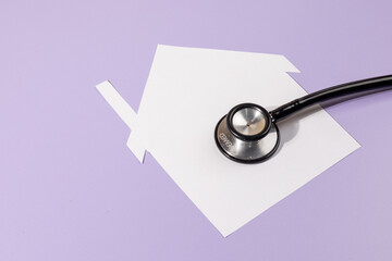 Home and Health Connection – Stethoscope with Paper House on Desk