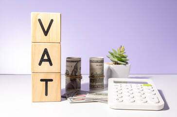 VAT Wooden Cubes with Cash and Calculator – Taxation Concept