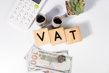 VAT Wooden Cubes with Cash and Calculator – Taxation Concept