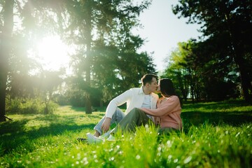 Couple enjoying a romantic moment in a sunlit park in spring