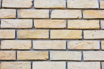 Textured yellow brick wall enhances urban architecture and design appeal in interior spaces