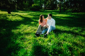 Couple enjoying a sunny moment in a serene green park setting