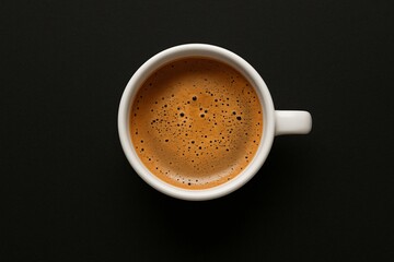 Coffee cup with foam bubbles viewed from above