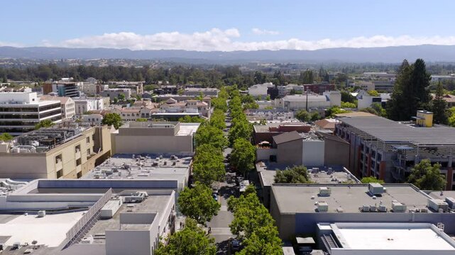 Palo Alto - Low Aerial Approach Over University Ave with Pedestrians Crossing Street 