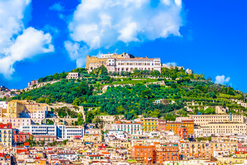 Aerial view of Naples, Italy, capturing its vibrant and colorful urban fabric with tightly packed buildings, historic rooftops, and Mediterranean charm spreading across the hillsides