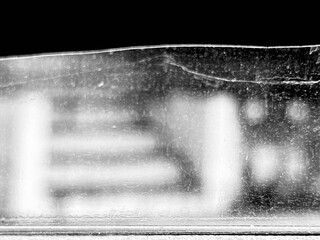 photograph of a vehicle window, with a blurred staircase in the background.