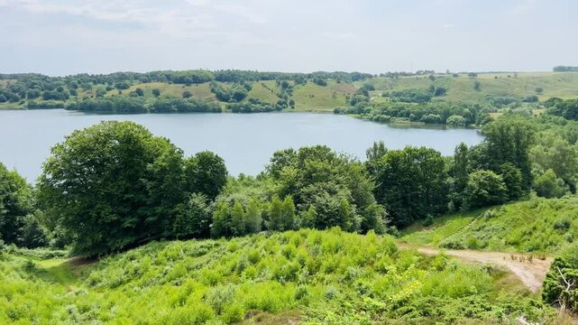 View over Hald Lake from Dollerup bakker, Viborg, Denmark. Tree row avenue at Hald lake. Heather lands. The Manor House of Hald in Dollerup, beautiful location of this historical building. Nice park 