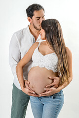 Happy and loving expecting parents.
Husband kissing and supporting his pregnant wife.