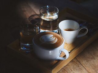 Warm Coffee and Water Glasses on Wooden Tray in Natural Light