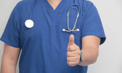 Dark-skinned Latino male specialist doctor with a stethoscope shows a like sign with his hands as a...