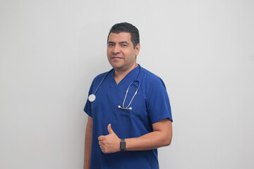 Dark-skinned Latino male specialist doctor with a stethoscope shows a like sign with his hands as a sign of approval and liking