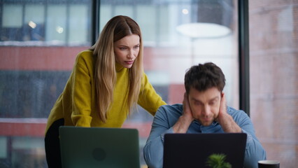 Professional trainer teaching intern dissatisfied work at laptop office closeup.