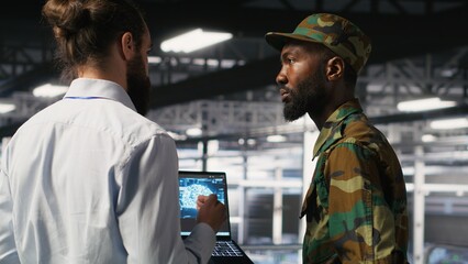 Army technicians in command center server room using artificial intelligence to detect cyber...
