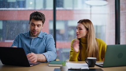 Team members discussing project looking laptop at office open space closeup. 