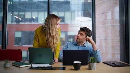 Woman boss supervising employee work in office coworking. Smiling businesswoman
