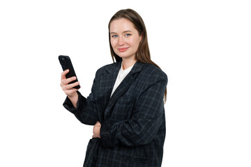 Fototapeta premium Confident young woman in a business outfit smiles while holding a smartphone in her hand, showcasing a modern professional vibe