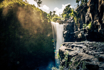 Golden Mist Over Jungle Waterfall at Sunrise