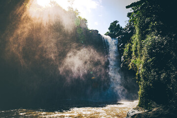 Golden Mist Over Jungle Waterfall at Sunrise