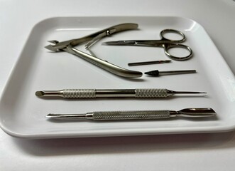 Professional manicure tools on white tray closeup