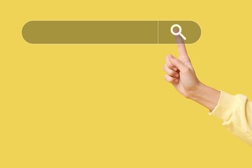 Hand using web search engine on yellow background