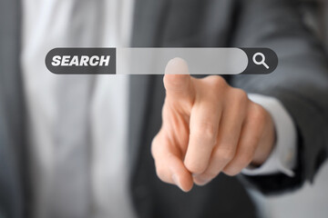 Young businessman using virtual screen in office, closeup