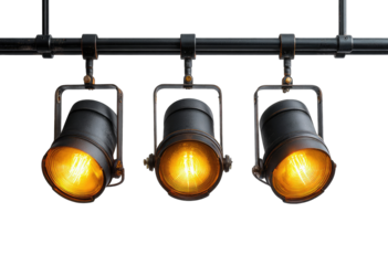 Three vintage-style spotlights hang from a black industrial pipe, emitting warm yellow light against a dark background
