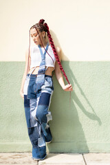 Portrait of a woman in unique denim and red braids