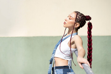 Woman leaning on a railing with distinctive hair style