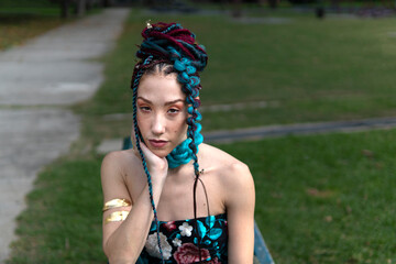 Woman with unique hair and fashion in a green city space