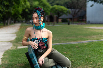 Woman with braids and strong personal style sitting outdoors