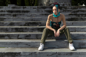 Bohemian street style featuring long braided hair with colorful accents