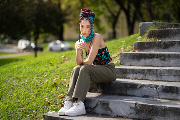 Expressive model with long, styled braid extensions in an urban landscape
