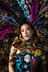 Artistic shot of a woman amidst autumn foliage